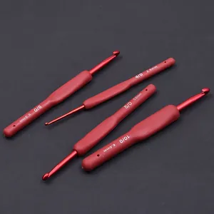 Detailed view of red soft-grip aluminum crochet hooks set with sizes 2.5mm to 6.0mm