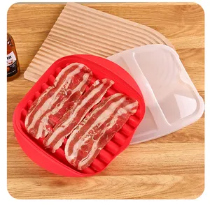 Microwave bacon cooker tray with lid showing raw bacon strips on a warm wooden background