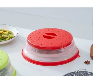 Detail view of red collapsible silicone microwave splatter cover on kitchen counter