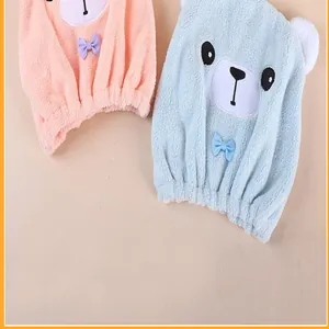 Close-up of cute cartoon bear hair drying caps in soft pink and blue microfiber