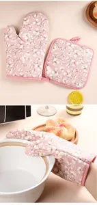 Detail view of pink floral kitchen heat resistant oven mitt and pot holder set for baking.