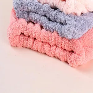 Detail view of soft absorbent microfiber hair drying towels in pink and grey tones