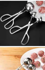 Detailed view of large and small stainless steel meatball scoops with raw meatballs on plate