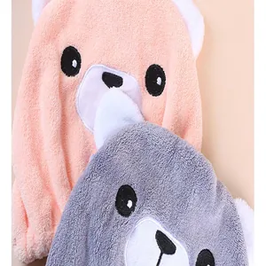 Close-up macro view of soft absorbent cartoon bear hair drying caps in pink and grey