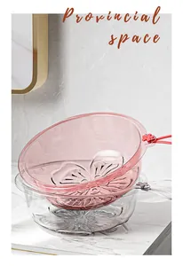 Close-up of pink and clear plastic washbasins with cherry blossom pattern