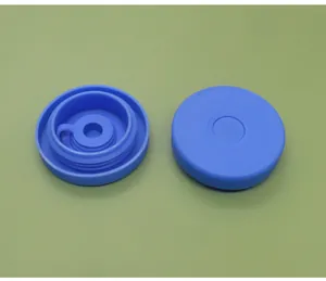 Detail view of blue silicone water bucket seal caps showing top and bottom structure