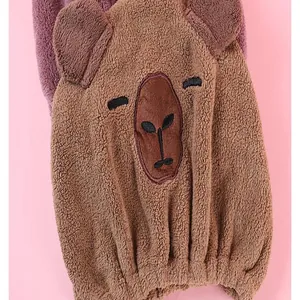 Close-up of fluffy bear-shaped quick-dry hair cap with soft coral fleece texture