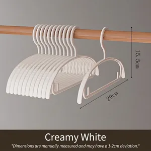Close-up detail of cream white non-marking baby plastic hanger with 29cm width measurement