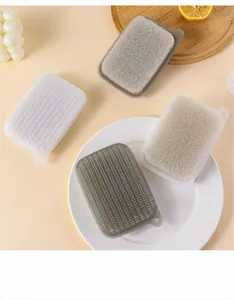Detail view of dual-sided kitchen sponges with bristles and hanging holes for deep cleaning.