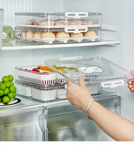 Stackable transparent refrigerator organizer bins with lids and food storage timer dial.