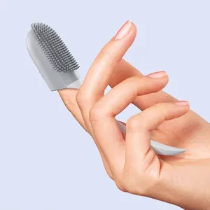 Soft silicone pet finger toothbrush with long handle for deep oral cleaning.
