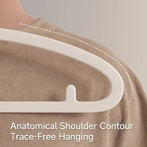 Close-up of ergonomic curved shoulder on white seamless anti-slip clothes hanger
