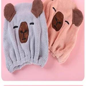 Macro detail of cartoon bear microfiber hair drying caps in grey and peach colors
