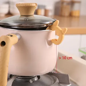 Rabbit shaped silicone pot lid lifter and spill stopper on a pink pot
