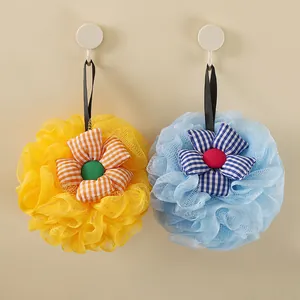 Detailed view of yellow and blue sunflower bath sponges with gingham fabric flowers.