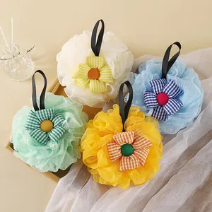 Detailed view of four soft mesh bath balls featuring colorful decorative plaid sunflowers