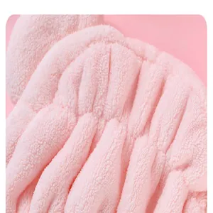 Close-up macro detail of soft pink coral fleece quick-dry hair drying towel cap texture