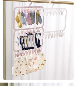 Folding plastic drying rack with multiple clips for socks and baby clothes in usage