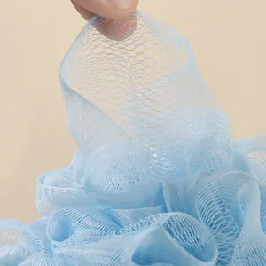 Close-up detail of light blue soft mesh bath ball showing durable fine mesh texture