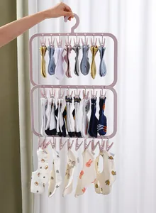 Multi-tier pink laundry drying rack with clips holding various socks and baby bibs