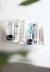 Close-up detail of a clear wall-mounted organizer storing various skincare tubes