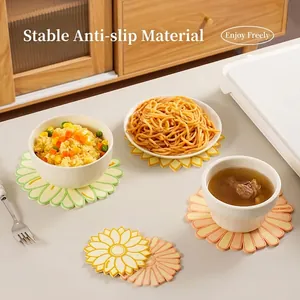 Daisy-shaped heat-resistant soft rubber coasters in multiple colors for dining tables
