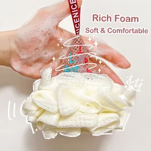 Creative ice cream shaped bath sponge in white mesh being used with rich soap bubbles.