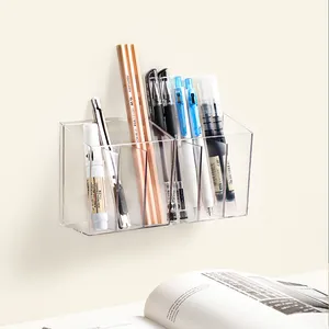 Wall-mounted clear acrylic organizer with multiple compartments for stationary or cosmetics.