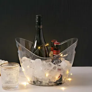 Large transparent acrylic boat-shaped ice bucket with ice and wine bottles at a bar