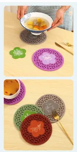 Macro view of multi-colored round silicone heat insulation mats on a wooden table surface