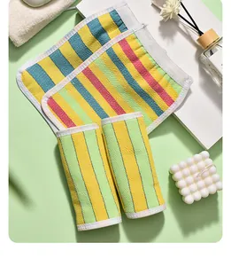 Detail of colorful striped exfoliating bath towels with spa-themed decorative props.