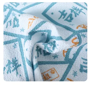 Macro detail of coarse sand texture on long blue back scrubber towel with traditional patterns