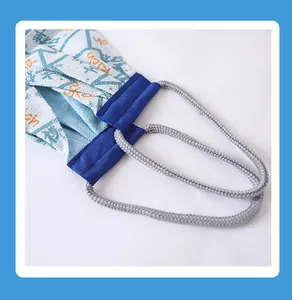 Close-up detail of back scrubber towel with durable woven rope handles and textured fabric