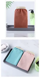 Close-up view of premium exfoliating bath mitts in various colors displayed on a bathroom tray