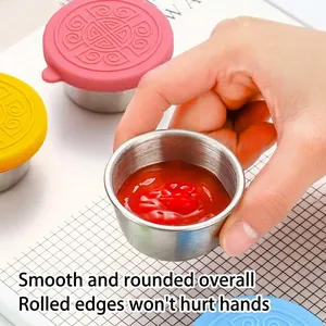 Small stainless steel sauce container with colorful leakproof silicone lid for dressings