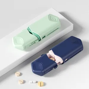 Portable telescopic pill cutter shown in mint green and navy blue for medical use