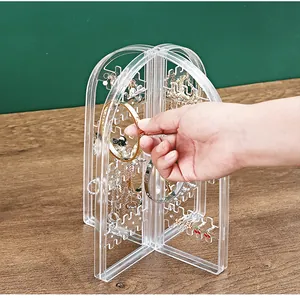 Macro view of transparent acrylic earring organizer stand with multi-layered hooks