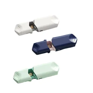 Compact portable sliding pill cutter available in white, blue, and green for medication