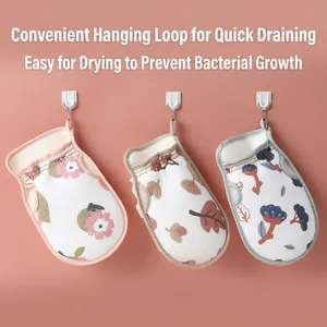 Three printed exfoliating bath mitts with lanyards for easy drying in the bathroom