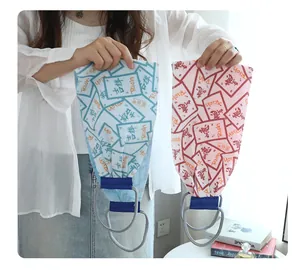Model holding long exfoliating back scrubber towels in blue and pink for body care