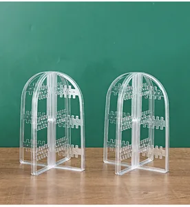Clear arch-shaped acrylic earring display stand with multi-tier hanging hooks for home storage
