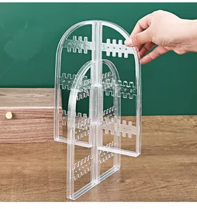 Detailed view of a transparent acrylic folding earring and jewelry display rack.