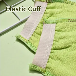 Light green exfoliating scrubbing bath glove with comfortable elastic wristband