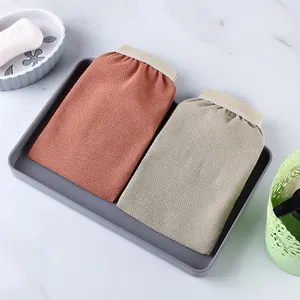 Pair of exfoliating bath gloves in brown and beige colors for deep body cleaning.