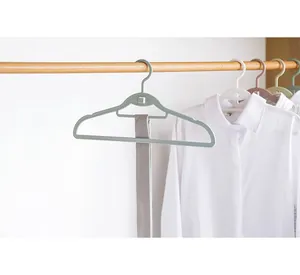 Modern multi-color plastic clothes hangers on wooden rail with tie hanging detail