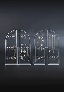 Clear acrylic arched jewelry organizers displaying multiple earrings and necklaces detail