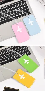 Detailed view of colorful PVC airplane luggage tags in pink, blue, green, and yellow