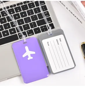 Close-up of PVC luggage tags with airplane icon and contact information card holder