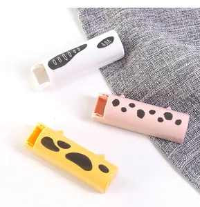 Detailed close-up view of portable cat-themed foldable lint rollers in three vibrant colors