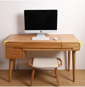 Bright yellow child safety corner protectors applied to a minimalist wooden desk edge